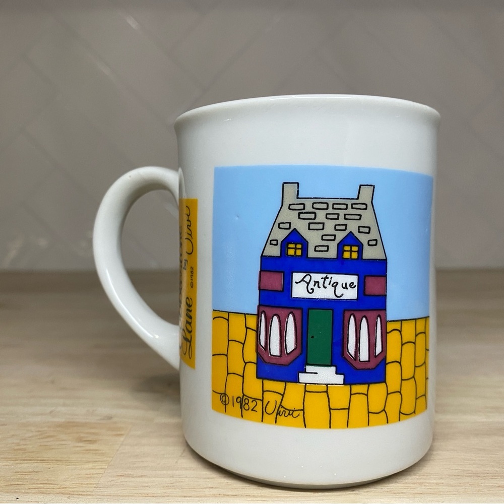 Cobblestone Lane by Vivi Mug Featuring an Illustration of an "Antique" Store